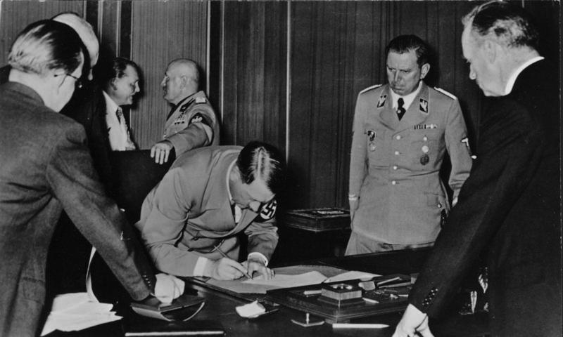 Adolf Hitler signing the Munich agreement after the negotiations